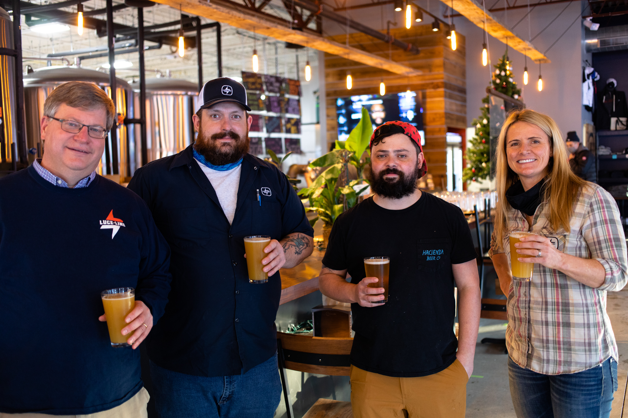 L to R: Luce Line co-founder and CEO Tim Naumann, taproom manager Todd Zallaps, head brewer Danny McMahon, and co-founder, COO, and CFO Kate Coward • Photo by Jordan Wipf