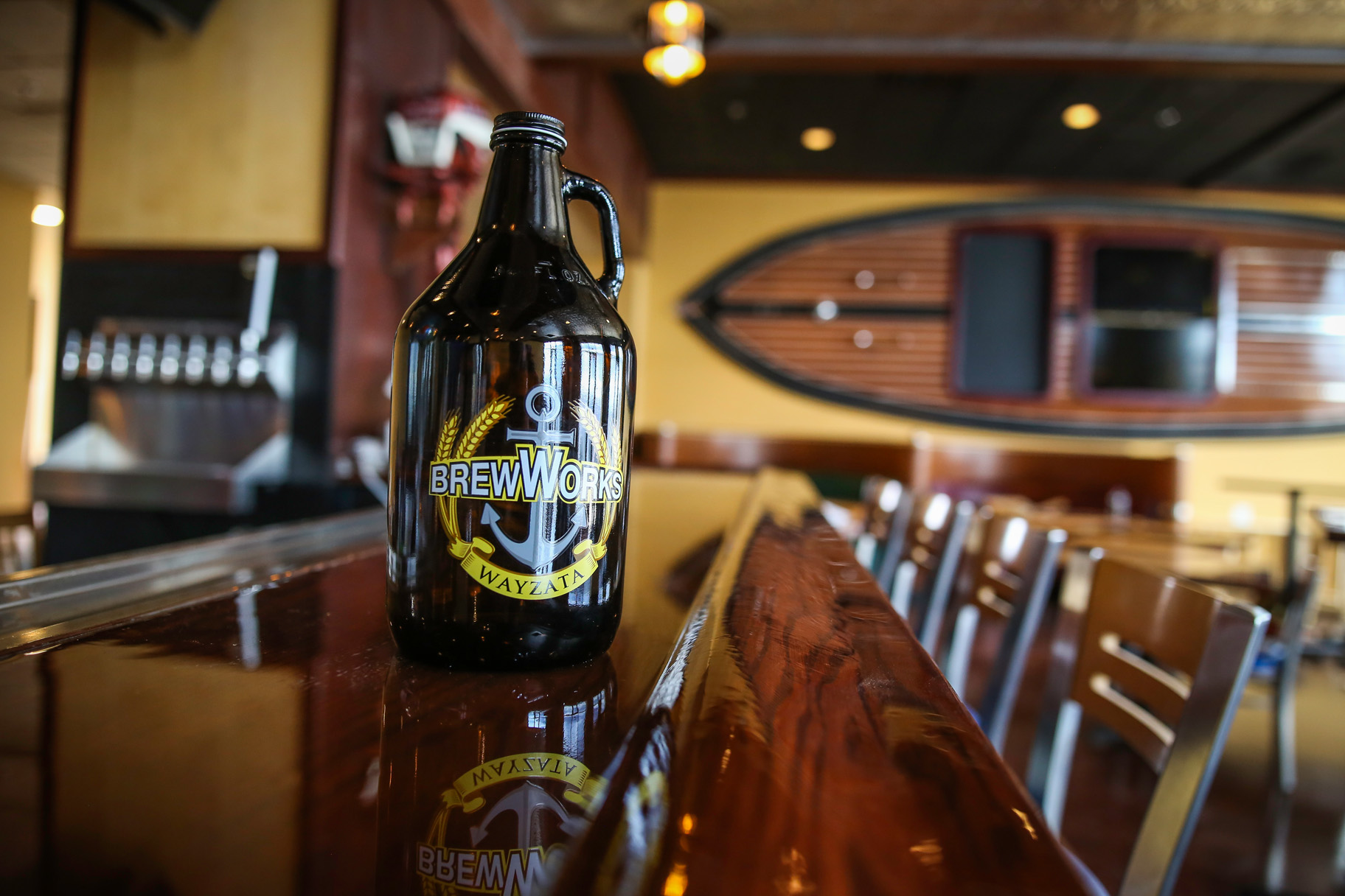 <em>A branded growler sits on the bar at Wayzata Brew Works around the time of the brewery's opening in 2016. • Photo by Aaron Davidson</em>