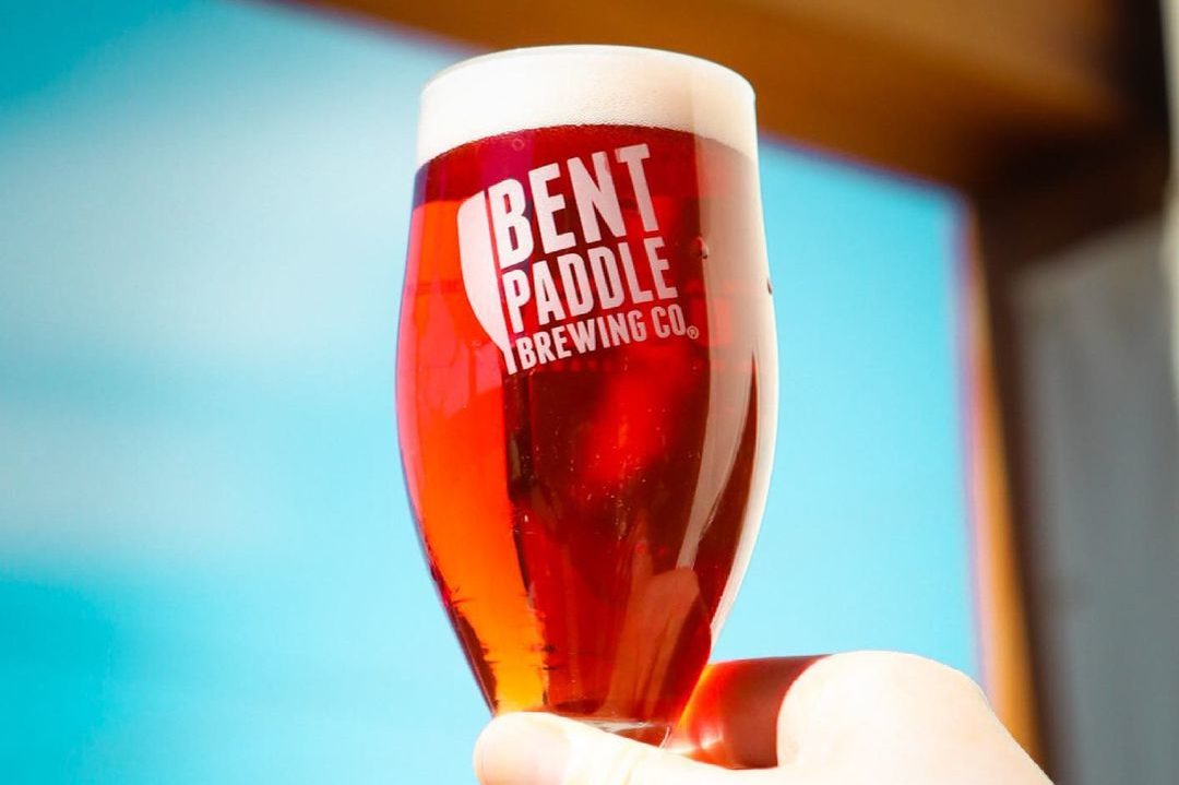 Bent Paddle Out of the Oak Honeyberry Saison • Photo via Bent Paddle Brewing Company