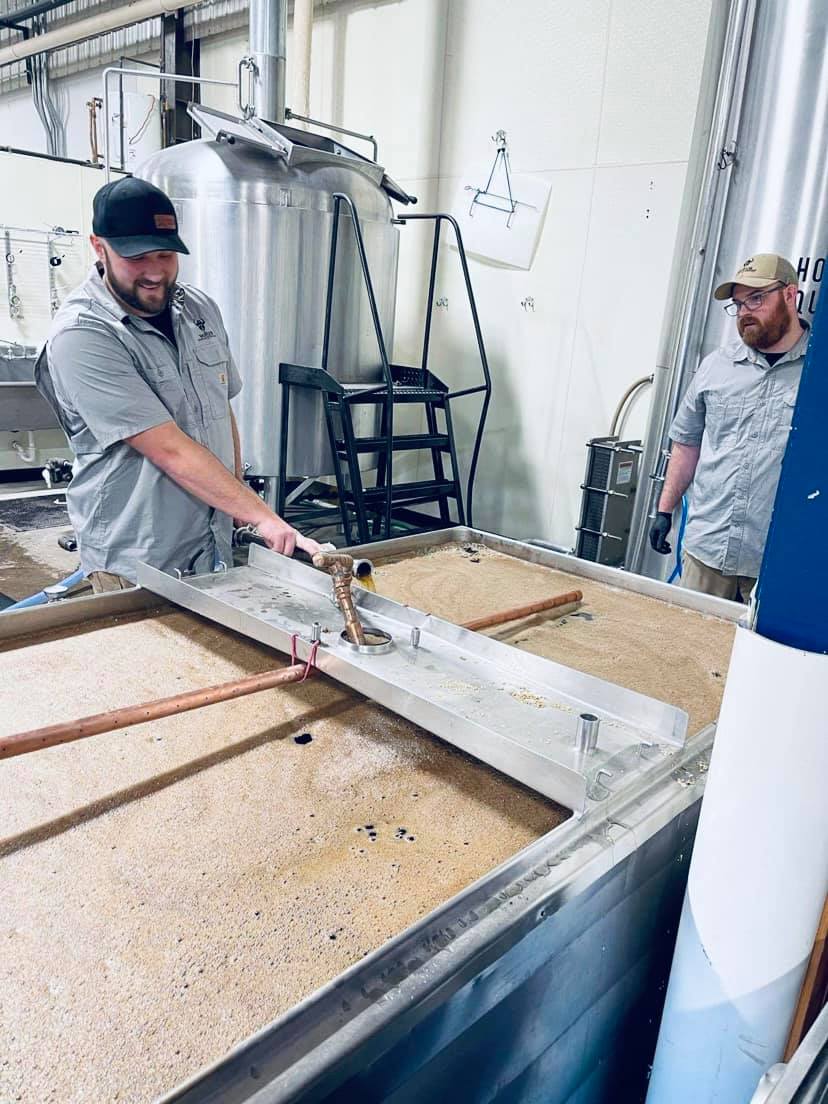 Warrior Brewing Company founders Matt Caple (left) and Benjamin Gipson mashing in at their new Duluth brewery • Photo via Warrior Brewing Company