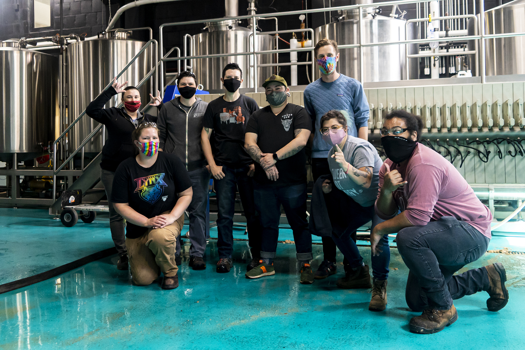 Tyler Mithuen (3rd from R) and Mai Jakubowski (2nd from R) pose with other members of Deviant Minds during a brew day at Modist Brewing Company • Photo via Deviant Minds