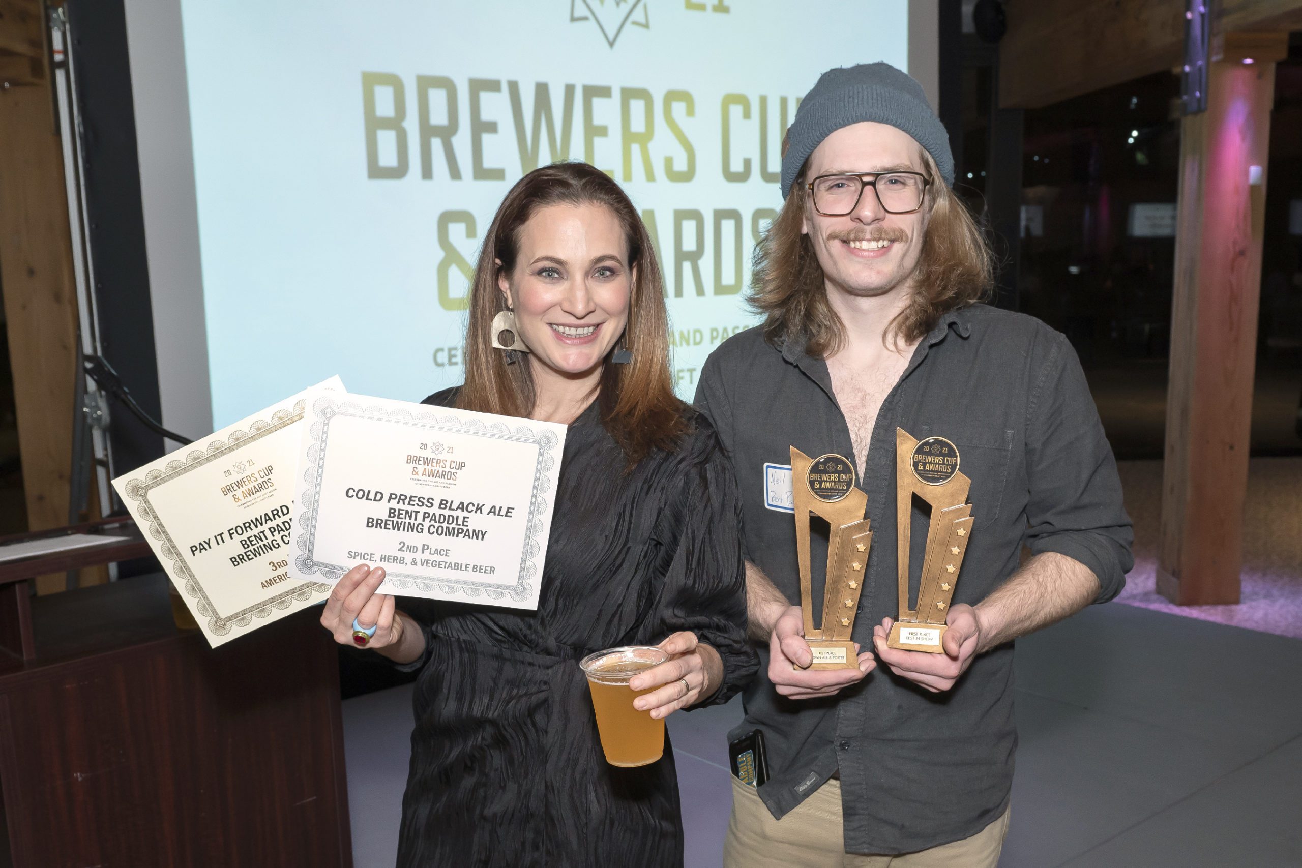 Bent Paddle co-founder Laura Mullen (left) celebrates winning gold and Best In Show at the 2021 Brewers Cup Awards • Photo courtesy Minnesota Craft Brewers Guilde