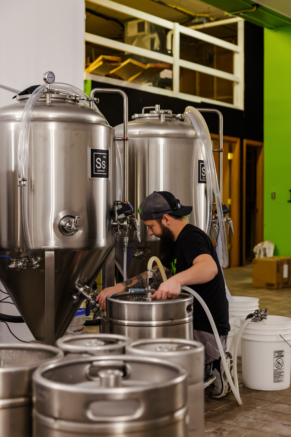 Hop & Barrel Brewing Spring Valley's head brewer Jason Pahl transfers beer from a fermentor into a keg • Photo courtesy Hop & Barrel Brewing Company